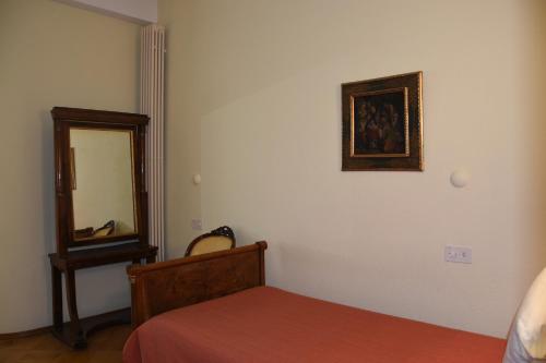 a bedroom with a bed and a mirror on the wall at Casa Santa Birgitta in Lugano