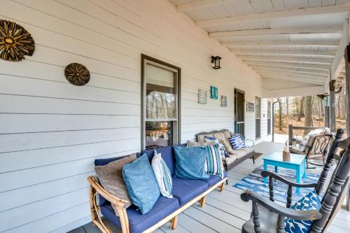 a porch with a blue couch and chairs at 3 Mi to Marietta Square Hot Tub Haven with 2 Patios in Marietta
