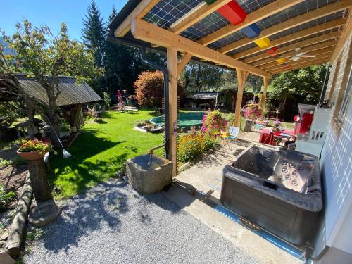 a patio with a sink under a wooden pergola at Ferienhaus-Römerthurm in Schöder