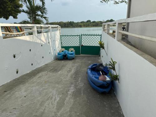 two blue bags sitting on a balcony next to the water at Los Veleros in Ceiba Rica