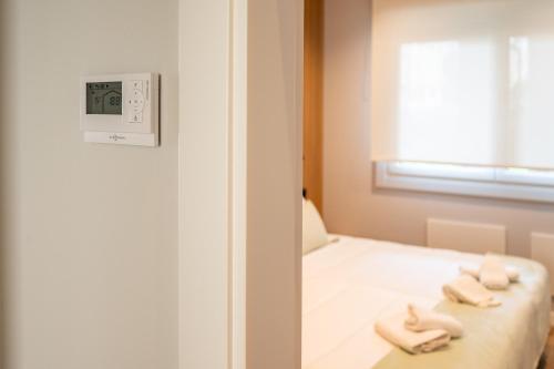 a room with a bed with two towels on it at White Tree By Arca Hostel in O Pedrouzo