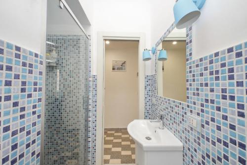 a bathroom with a toilet and a sink and a mirror at Stella Polare Sensorial Home in Lido di Ostia