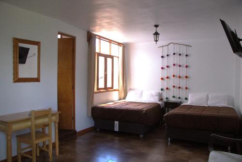 Postel nebo postele na pokoji v ubytování Casa Munayki