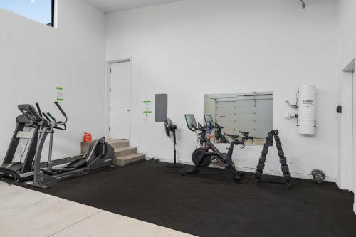 a gym with several treadmills and cardio machines at Mtn Views and Private Hot Tub Luxe Tetonia Retreat in Tetonia