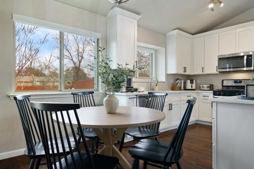 a kitchen with a wooden table and chairs and a table at Pool,Games & Chill Vibes in Cedar Park