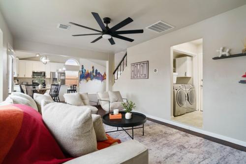 a living room with a couch and a ceiling fan at Pool,Games & Chill Vibes in Cedar Park