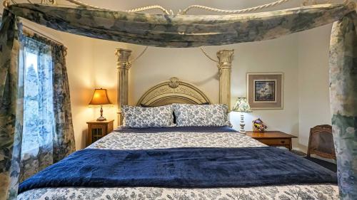 a bedroom with a bed with a canopy at Sq Sequim Sunrise Apartment in Sequim