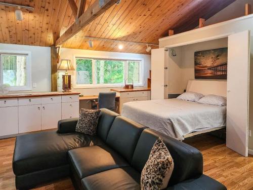 a living room with a bed and a couch at Sq Gretas Place in Sequim