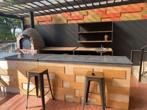 a bar with two stools and a pizza oven at Air Suites Hotel Boutique in Quito