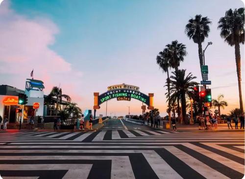 an empty street with a crosswalk in a city with palm trees at Spacious Single Apt D In Santa Monica in Los Angeles