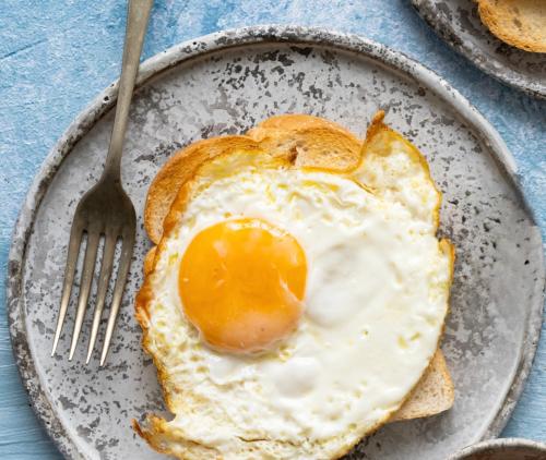 a fried egg on a plate with a fork at Travel Hotel Quito in Quito