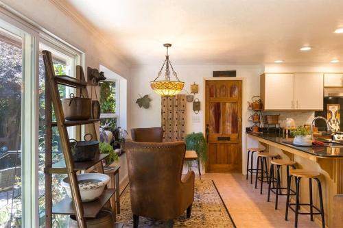 a kitchen with a bar with stools and a counter at Sq Wild Rose 2 in Sequim