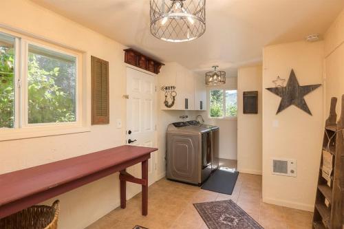a kitchen with a refrigerator and a star on the wall at Sq Wild Rose 2 in Sequim