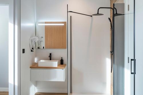 a bathroom with a sink and a shower at White Tree By Arca Hostel in O Pedrouzo