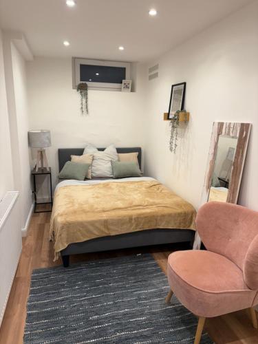 a bedroom with a bed and a mirror and a chair at Miltenberg Moments Ferienwohnung in Miltenberg