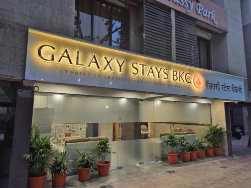a building with a sign that reads calley stays big at Galaxy Stays BKC in Mumbai