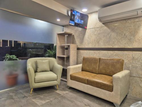 a living room with a couch and a chair at Galaxy Stays BKC in Mumbai