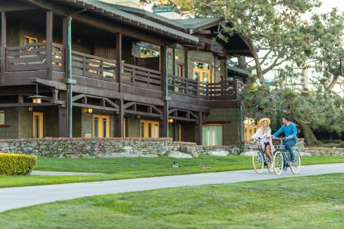 a man and a woman riding bikes in front of a building at The Lodge at Torrey Pines in San Diego