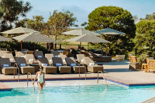 a woman standing in the water in a swimming pool at The Lodge at Torrey Pines in San Diego