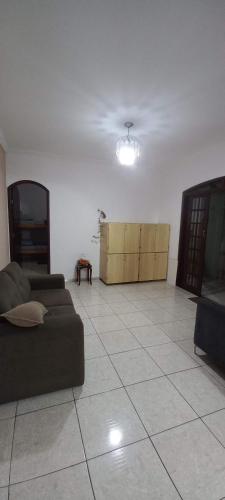 a living room with a couch and a table at Hostel Recanto do Descanso in Guarulhos