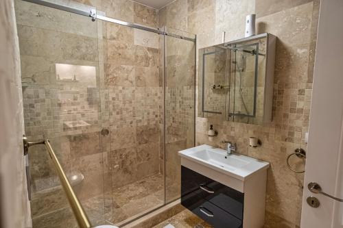 un bagno con lavandino e doccia di Solid Residence Apartments a Mamaia