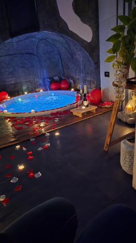 a room with a large swimming pool with blue water at Elite Apartment SPA in Catania