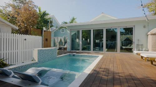 a backyard with a swimming pool and a house at Sombrero Reef Light Suite in Key West
