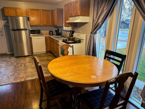 a kitchen with a wooden table and a table and chairs at Perfect for West End Shopping in Billings
