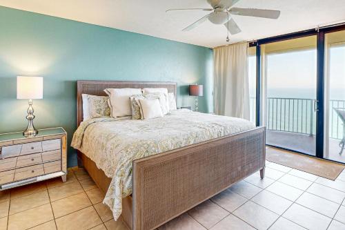 a bedroom with a large bed and a balcony at Peaceful Paradise in Daytona Beach Shores