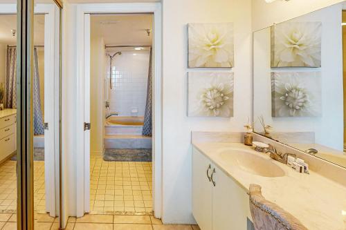a bathroom with a sink and a tub at Peaceful Paradise in Daytona Beach Shores