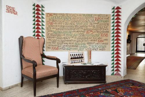 a chair and a table in a room with a wall at Brauereigasthof-Hotel Roter Ochsen in Ellwangen