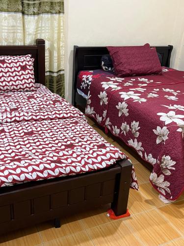 two beds sitting next to each other in a room at T&Z Homestay in Melaka