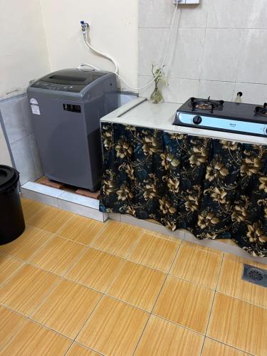 a kitchen with a counter with a stove at T&Z Homestay in Melaka
