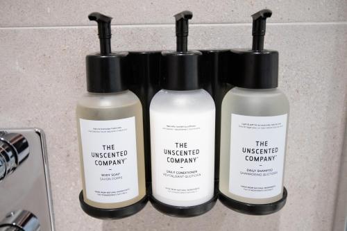 three bottles of the unexpected company products on a counter at Studio #15 - Self Check-In - Plateau - St-Denis in Montréal
