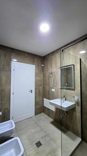 a bathroom with a shower and a sink and a glass door at Lake By Apartment in Sauk