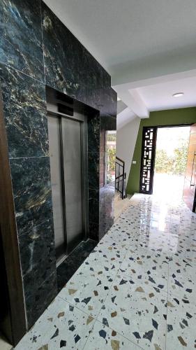 a hallway with a tile floor and a wall at Lake By Apartment in Sauk