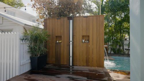 a wooden privacy fence next to a swimming pool at Tortugas Harbor Light Suite in Key West