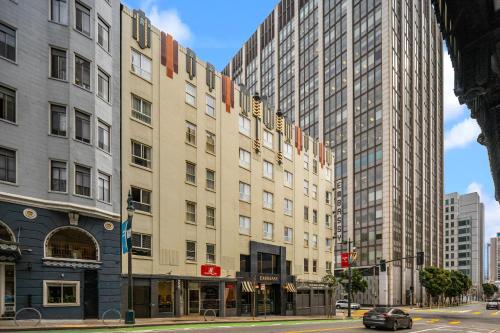 a building on a city street with tall buildings at EMBASSY HOTEL in San Francisco