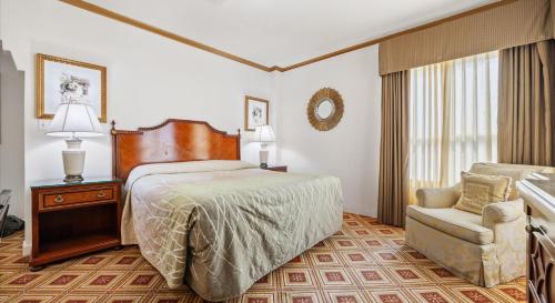a hotel room with a bed and a chair at EMBASSY HOTEL in San Francisco