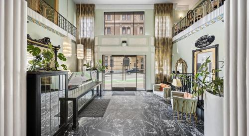 a hallway with a lobby with plants and a building at EMBASSY HOTEL in San Francisco