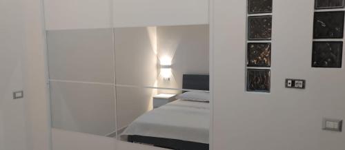 a bedroom with a bed and a glass wall at Jenny's house in Castellammare di Stabia