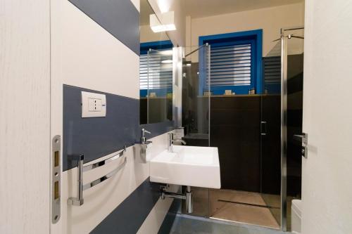a bathroom with a sink and a mirror at Solmaris Seaside - Luxury B&B sul mare a Campomarino in Maruggio