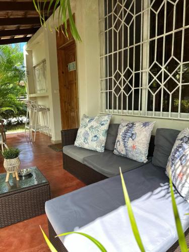 a living room with a couch and a table at 21 Palms in Las Galeras