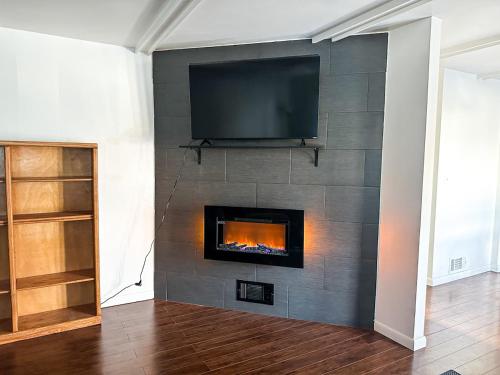 a fireplace with a flat screen tv on a wall at Perfect for West End Shopping in Billings