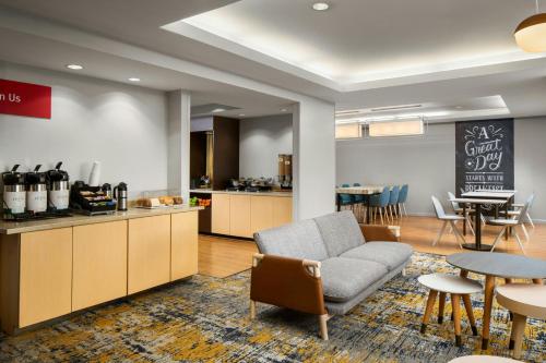a living room with a couch and a table and chairs at TownePlace Suites by Marriott Florence in Florence