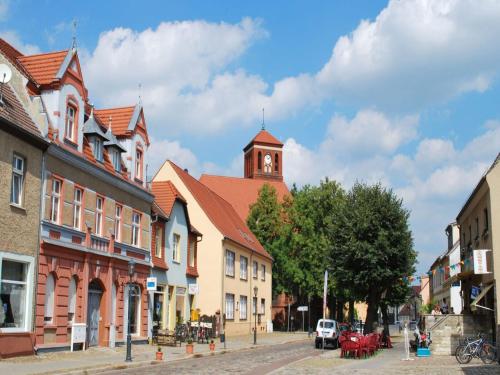 a street in a town with a clock tower at Ferienhaus Zum Storchennest in Storkow in Storkow