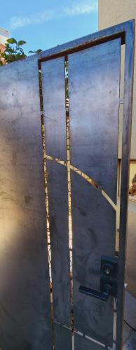 a metal door with a cross on top of it at Intimate Townhome Sanctuary DT in Albuquerque