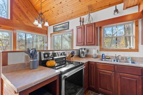 a kitchen with wooden cabinets and a stove top oven at Mountain Spirit in Stanton
