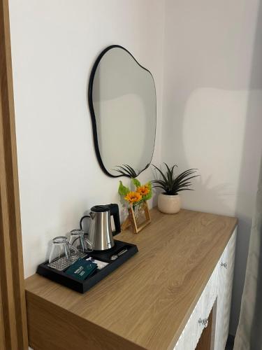 a mirror sitting on top of a wooden counter at Casa de Vacanta Magherus in Topliţa