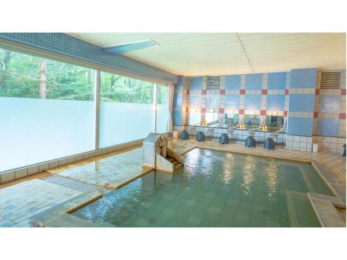 a pool of water in a large room with at Villa Inawashiro - Vacation STAY 27679v in Inawashiro